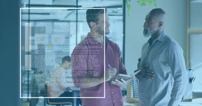 Discussing two colleagues in maroon and light gray shirts near glass data overlay, holding notebook - Powered by Adobe