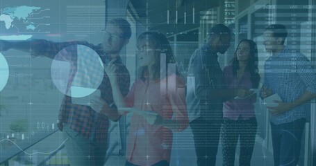 Pointing five coworkers examining writable glass at office with data overlays business-casual