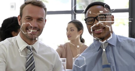 Smiling two men sitting in conference room in collared shirts and ties, showing molecular overlays
