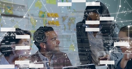 Discussing four colleagues wearing blazers reviewing data overlay in meeting room with laptops, map