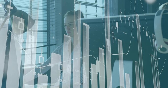 Analyzing woman in blouse and blazer viewing candlestick charts at office on screen headset visible