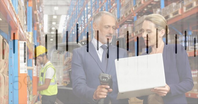 Reviewing stock managers suit or blazer using laptop scanner in warehouse, hi-vis-vest yellow-hardha - Powered by Adobe