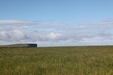 Scenic coastal landscape of Birsay, Orkney, featuring windswept beaches, rocky shores, and sweeping ocean vistas of northern Scottish coastline