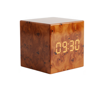 Modern wood burl cube digital alarm clock displaying 09:30 with warm light