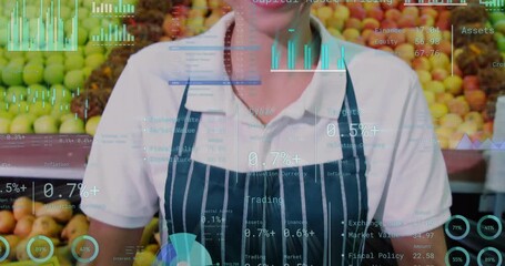 Camera pulling up from basket clerk smiling promoting fruit while HUD over clerk showing costs - Powered by Adobe