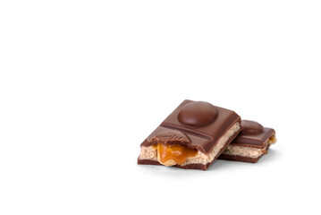 Chocolate bar with caramel, nougat and nuts filling isolated on white background.