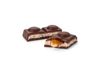 Chocolate bar with caramel, nougat and nuts filling isolated on white background.