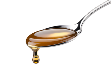 Golden caramel dripping from a silver spoon delicious and glossy on transparent background.