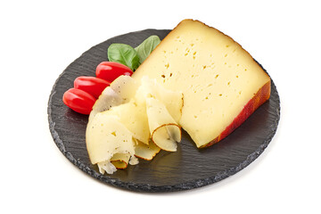 Cheese Wedge with Tomatoes and Basil on black stone slate plate, isolated on white background