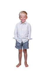 A 5-year-old boy laughs infectiously. The child, wearing a light shirt and gray shorts, stands barefoot at full height with his hands in his pockets. Isolated on a white background. Vertical.