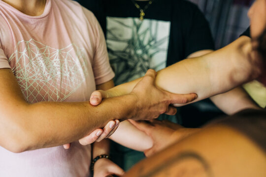 Group of people joining hands showing teamwork and unity
