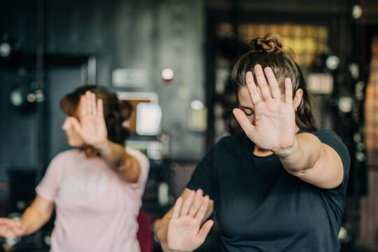 Women practicing tai chi pushing hands exercise