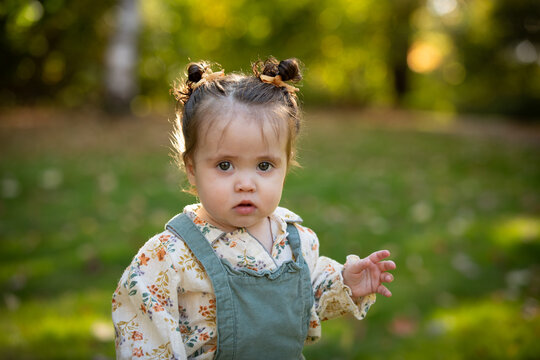Portrait of a cute toddler girl with buns in her hair