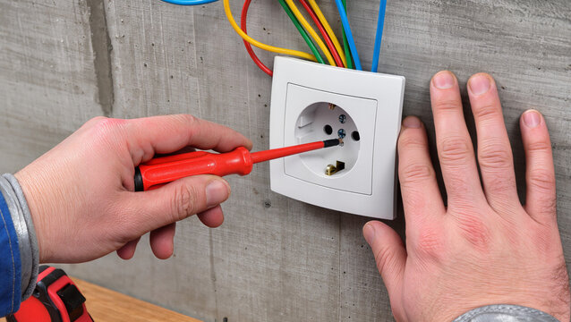 electrician working with electric plug