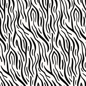 Seamless abstract pattern of zebra striped texture. Animal skin print in two colors. Simple repeat design of black textured stripes on white background. Grunge African motif tile. Vector illustration.