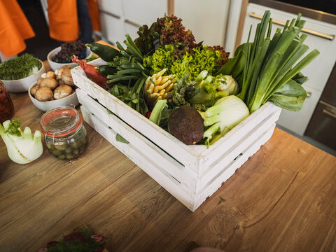 Box of fresh vegetables on kitchen table in cooking class