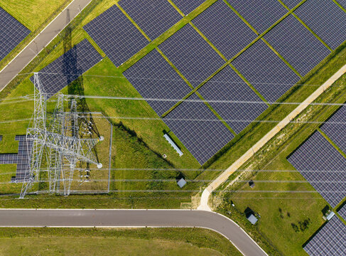 Aerial view of a solar farm and power lines in the Netherlands