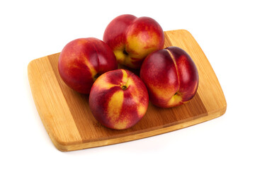 Nectarines on Wood Cutting Board, isolated on white background