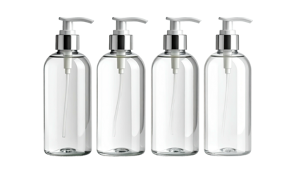 Four clear pump bottles, silver tops, against black backdrop