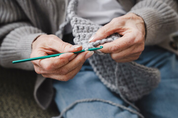 Senior woman knitting at home