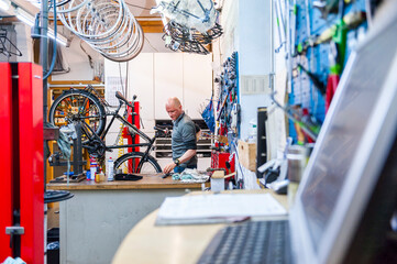 Bicycle mechanic working in bike shop