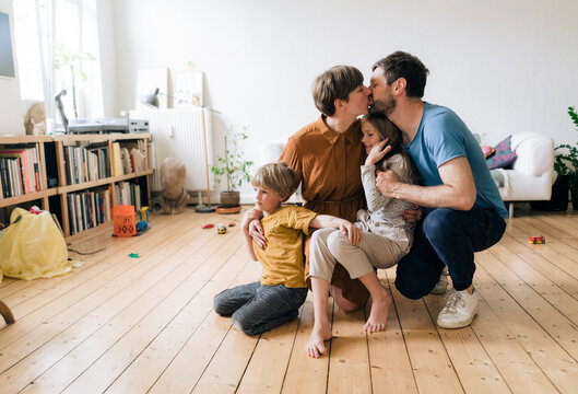 Romantic parents having fun with son and daughter at home