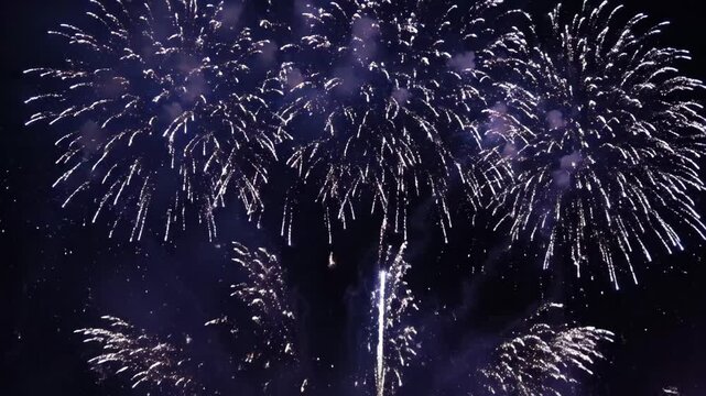 Vibrant fireworks display lighting up the night sky with dazzling blue explosions