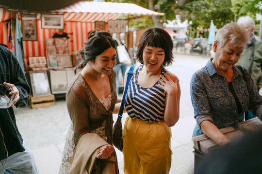Friends shopping at an outdoor flea market