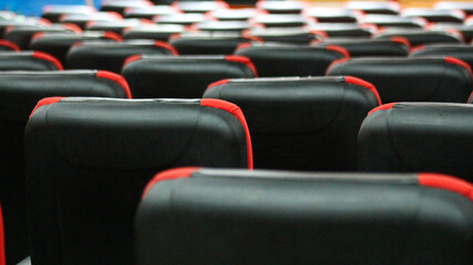 Empty rows of seats in the hall for large groups of people. Cinemas and theaters for watching shows.                               