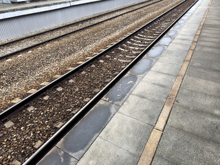 Yellow line on train platform indicates safe distance from the edge of the platform. Railroad safety, stand behind the line when boarding train to prevent accidents
