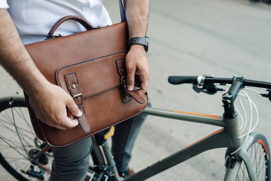 Man commuting to work by bicycle wearing business attire