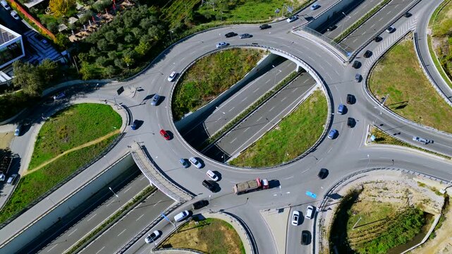 Top-down aerial video of Tirana&rsquo;s eastern highway roundabout showing traffic flow, modern infrastructure, and urban transport design.