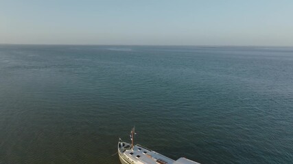 Wide view of a luxemotor boat on the edge of a channel with extensive sandbars and mudflats at Wadden sea.