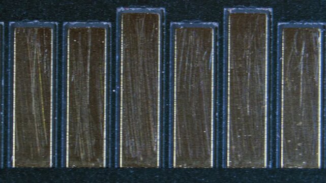 MicroSD card contacts with visible wear under microscope