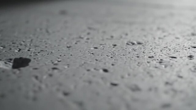 A detailed close-up shot of a textured, rough, gray surface with irregular patterns