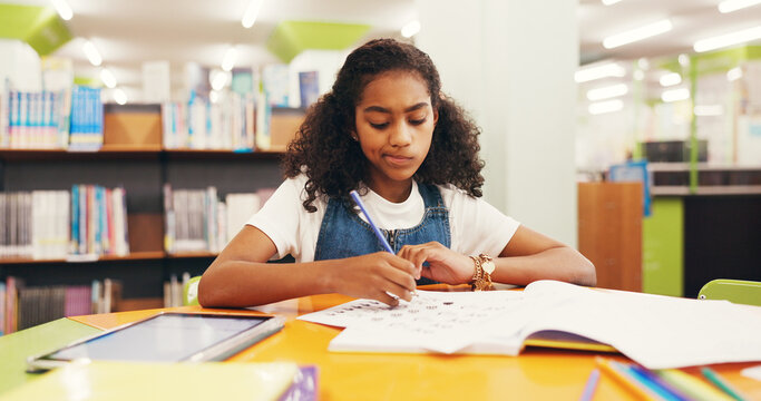 Library, student and child with test, writing and fine motor skills with knowledge, learn and growth. Education, cognitive development and girl with assignment, paperwork and exam for scholarship