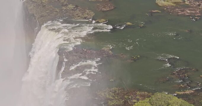 Victoria Falls Zimbabwe Aerial v5 zoomed birds eye view flyover around Devil's Pool capturing powerful flow of Zambezi River as it plunges into the gorge - Shot with Mavic 3 Pro Cine - Jan 3rd 2024