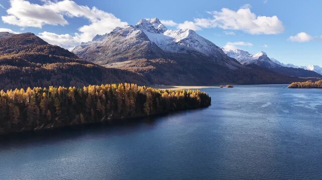 Walensee lake and Swiss alps mountains in autumn colors, drone flight over Amden and Walenstadt, Switzerland, peaceful alpine landscape with snow peaks, blue water and forest beauty.