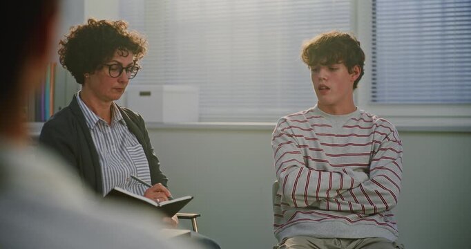 Modern Classroom Focuses on Student Mental Health as Teacher Leads Reflective Conversation and Takes Notes in Notebook. Concept Social Emotional Education, Self Care, Inclusive Learning Environment.