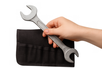 Hand holding a metal wrench over a black tool roll, representing concepts of service, fixing, and mechanical work