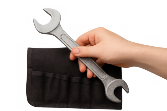 Hand holding a metal wrench over a black tool roll, representing concepts of service, fixing, and mechanical work - Powered by Adobe