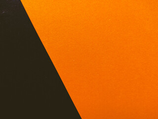 Black and orange color paper background, texture, copy space, diagonal.
