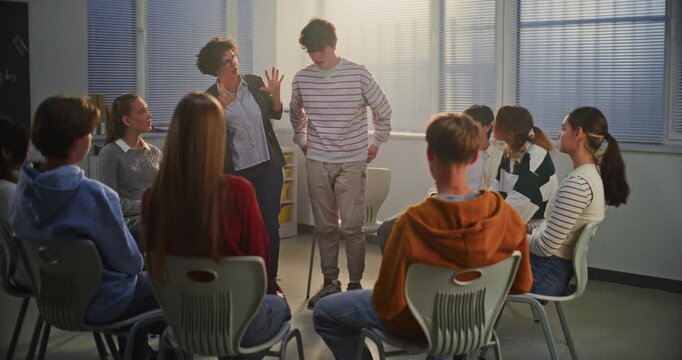 During Mental Health Class, Female Teacher Invites Boy to Perform Emotional Improvisation, Expressing Feelings Through Dialogue. Concept Experiential Learning, Emotional Release, and Self awareness.