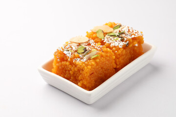 Orange boondi Halwa, garnished with roasted nutz and silver. Famous Indian dessert