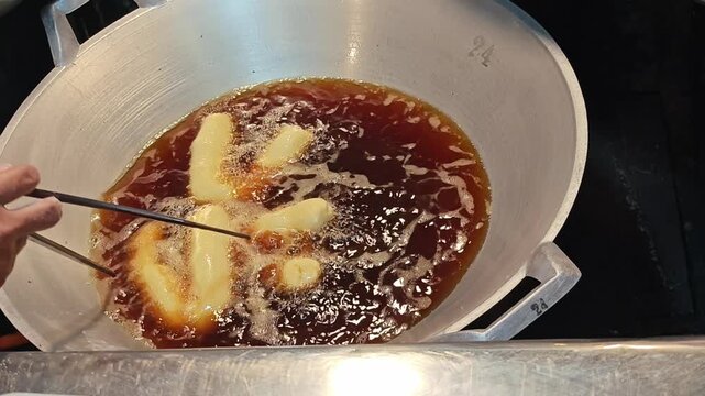 Deep fried dough stick in hot oil.