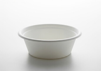 A small empty white ceramic ramekin dish with a slightly flared rim isolated on a pure white background for easy compositing and design isolated on white background