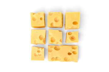 Maasdam cheese cubes isolated on white background.