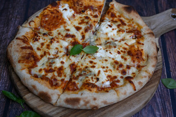 Home made classic Wood fired oved   Italian Pizza  quattro formaggi  Pizza with melted parmesan, gorgonzola, mozzarella and gouda  