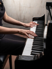 Elegant hands play a classical piano, creating beautiful melodies. This close-up captures a musician's focus and grace, perfect for themes of music, performance, and artistic expression.