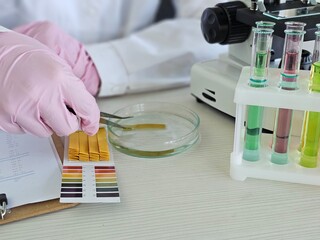 Research scientist conducting chemistry experiments with colorful reagents in laboratory